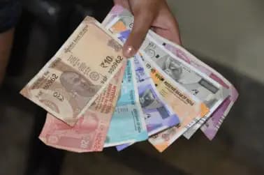 Rupee ends higher after U