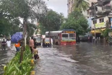 IMD red alert in Mumbai. Bus plies on a flooded street