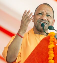 Yogi Adityanath, CHief Minister of Uttar Pradesh in saffron attire giving a speech