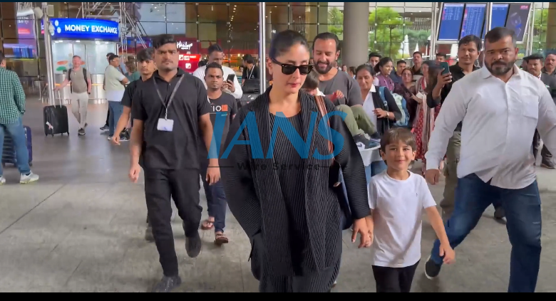 Karena Kapoor holding her son Taimur's hand while walking at the Mumbai international airport's arrival area