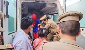 Police woman helping ayodhya gang rape victim to board an ambulance