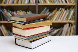 hardcover Books on the desk inside a library