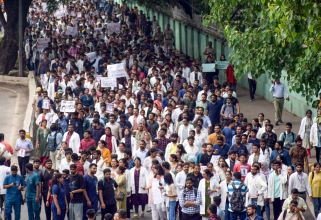 Members of the Federation of Resident Doctors Association (FORDA) hold posters during a protest at AIIMS, demanding justice for the woman PG trainee doctor who was found raped and murdered at RG Kar Medical College, New Delhi on Monday, August 12, 2024.(IANS/Wasim Sarvar)