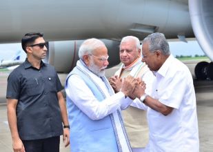 Pm MOdi at Kannur airport, Kerala being received by Chief Minister Vijayan. Governor Arif Md Khan is standing close by