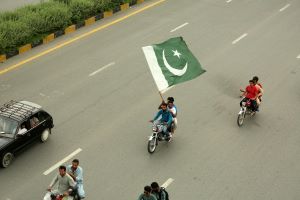 men on motors cycle with Pakistani Flag