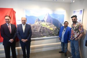 Dr Mukesh Batra showing his photos to zayed, diplomat at photography exhibition in Mumbai