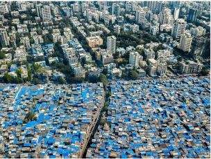 A photograph clicked in Mumbai shows the Dharavi slum area in the Maharashtra capital next to the nearby 'upscale' localities (File Image/ For representation)